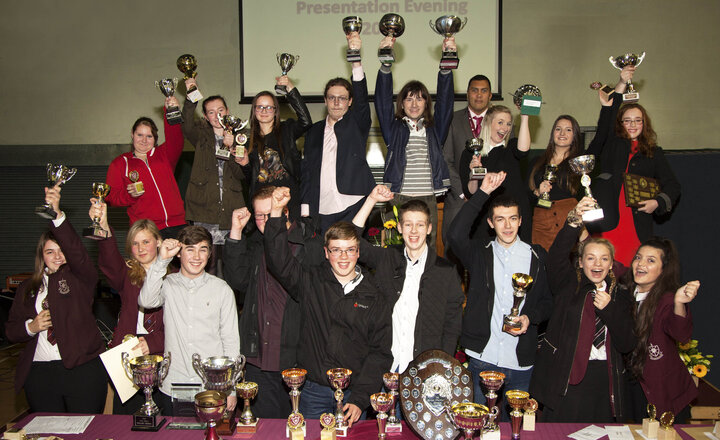 Image of Former Y11 students celebrate their achievements at Presentation Evening